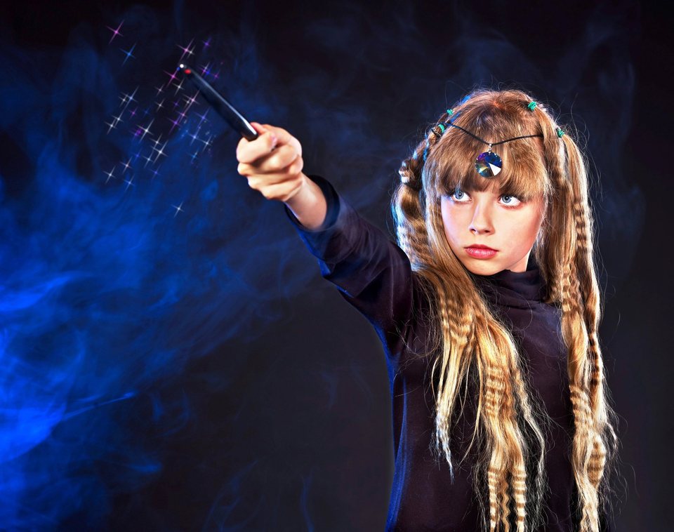 A girl creating a dramatic magical moment with a wand