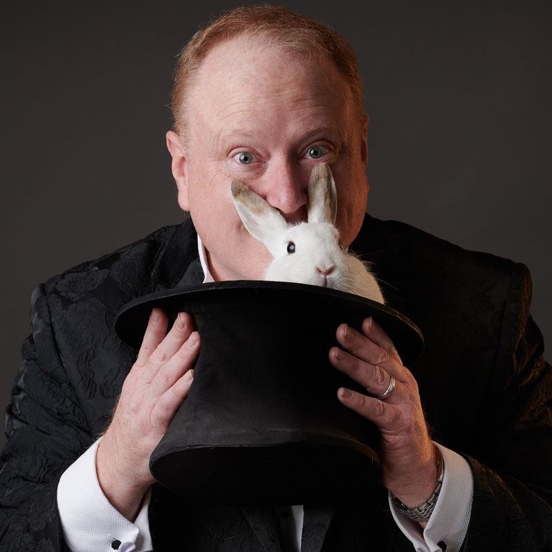 Jimmy Marvel presenting a rabbit from a top hat